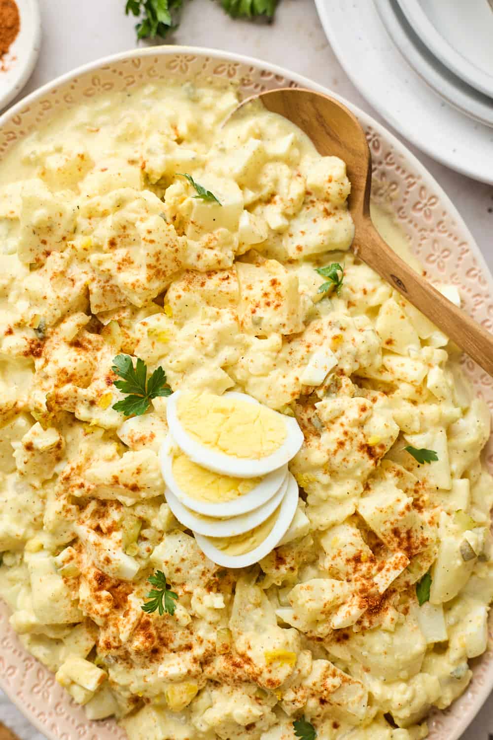 A large spoon digging into a creamy black southern potato salad recipe 