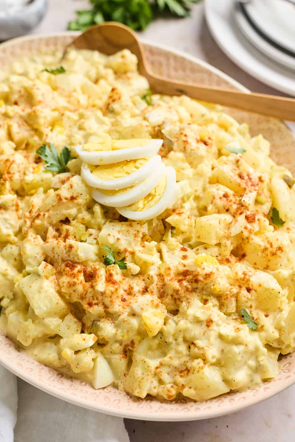 A spoon inside a southern potato salad before serving.