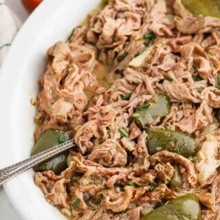 Chitterlings in a white plate with a spoon on it