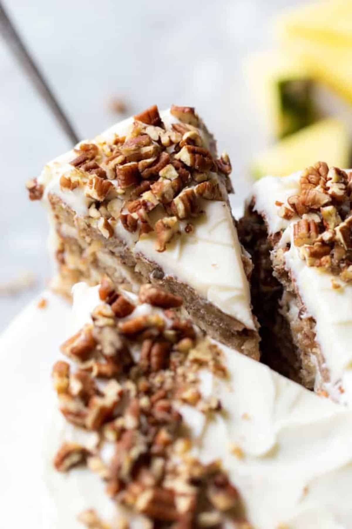 A slice of hum cake being removed to serve.