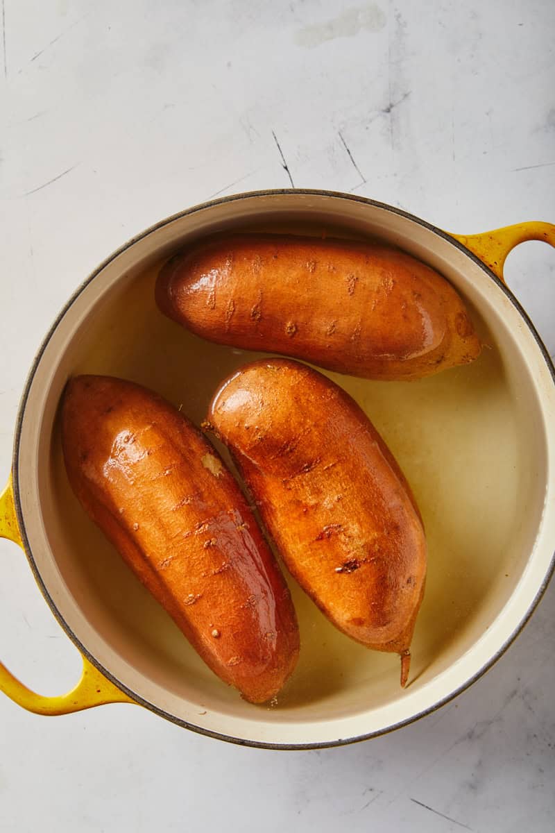 Sweet potatoes in water after being boiled to make a pie