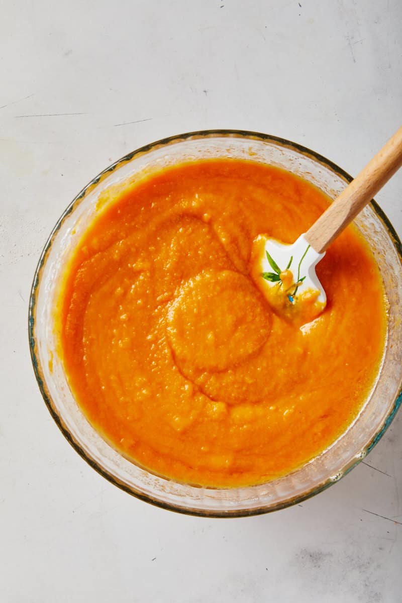 Smooth soul food sweet potato pie filling with a spatula being mixed together