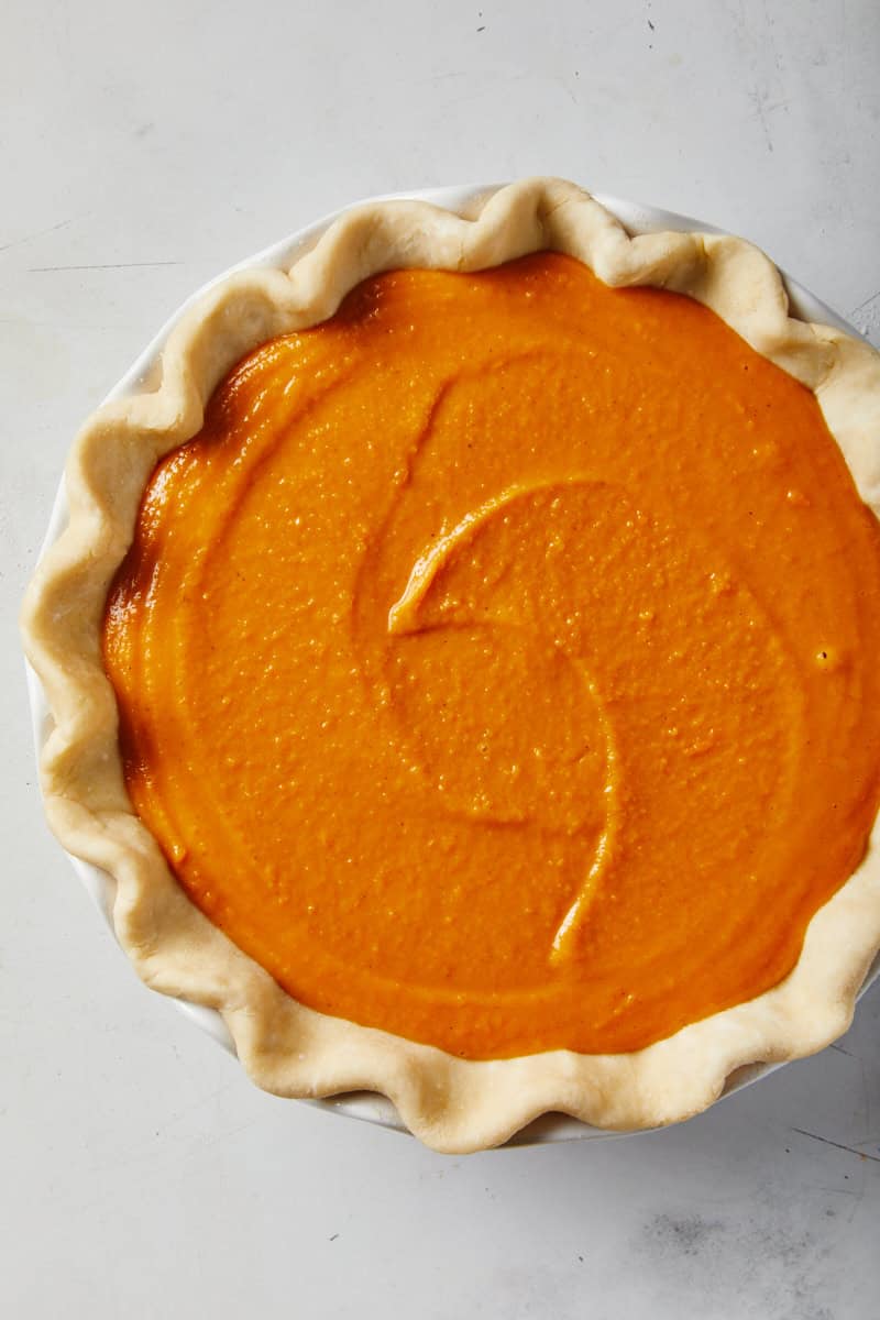 Black folks sweet potato pie filling added to pie crust before baked