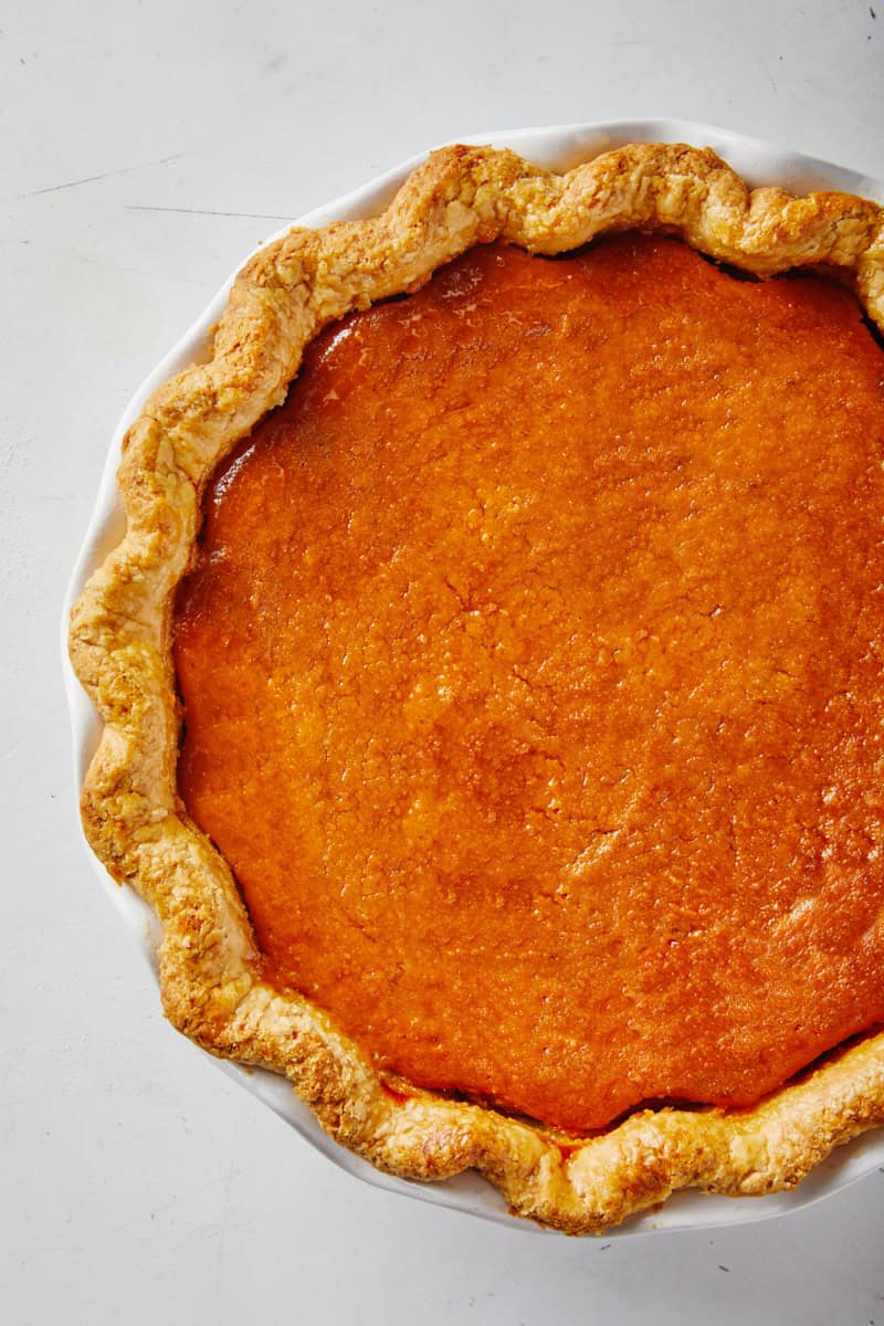 Baked soul food sweet potato pie on white background ready to enjoy