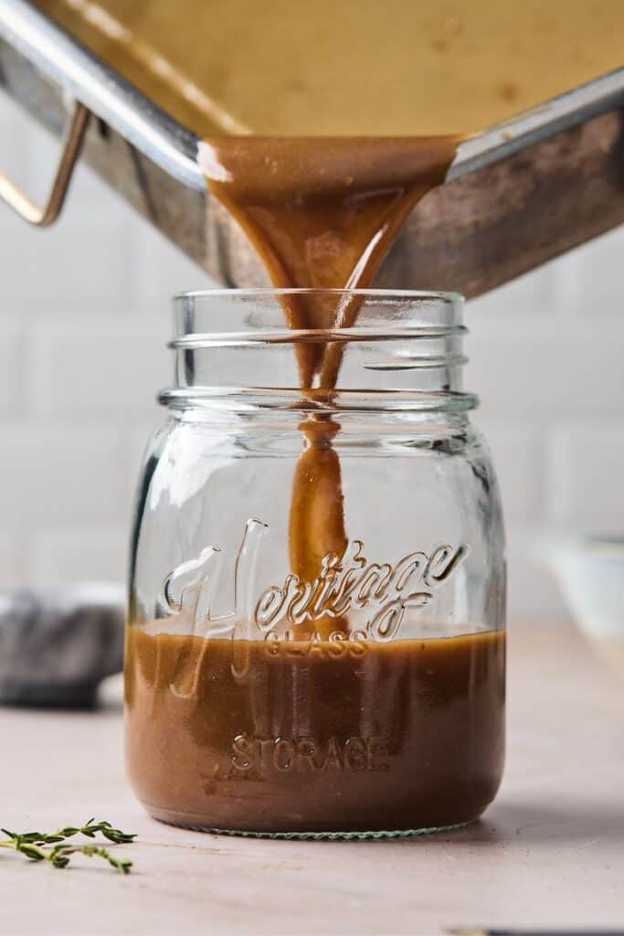 best au jus recipe being poured in a glass jar
