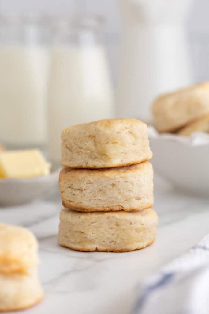 Three Southern biscuits stacked on top of each other on white countertop