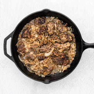 Flavorful liver and onions recipe sitting on a pan