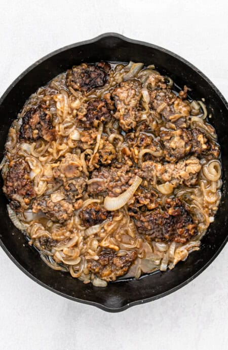 Flavorful liver and onions recipe sitting on a pan