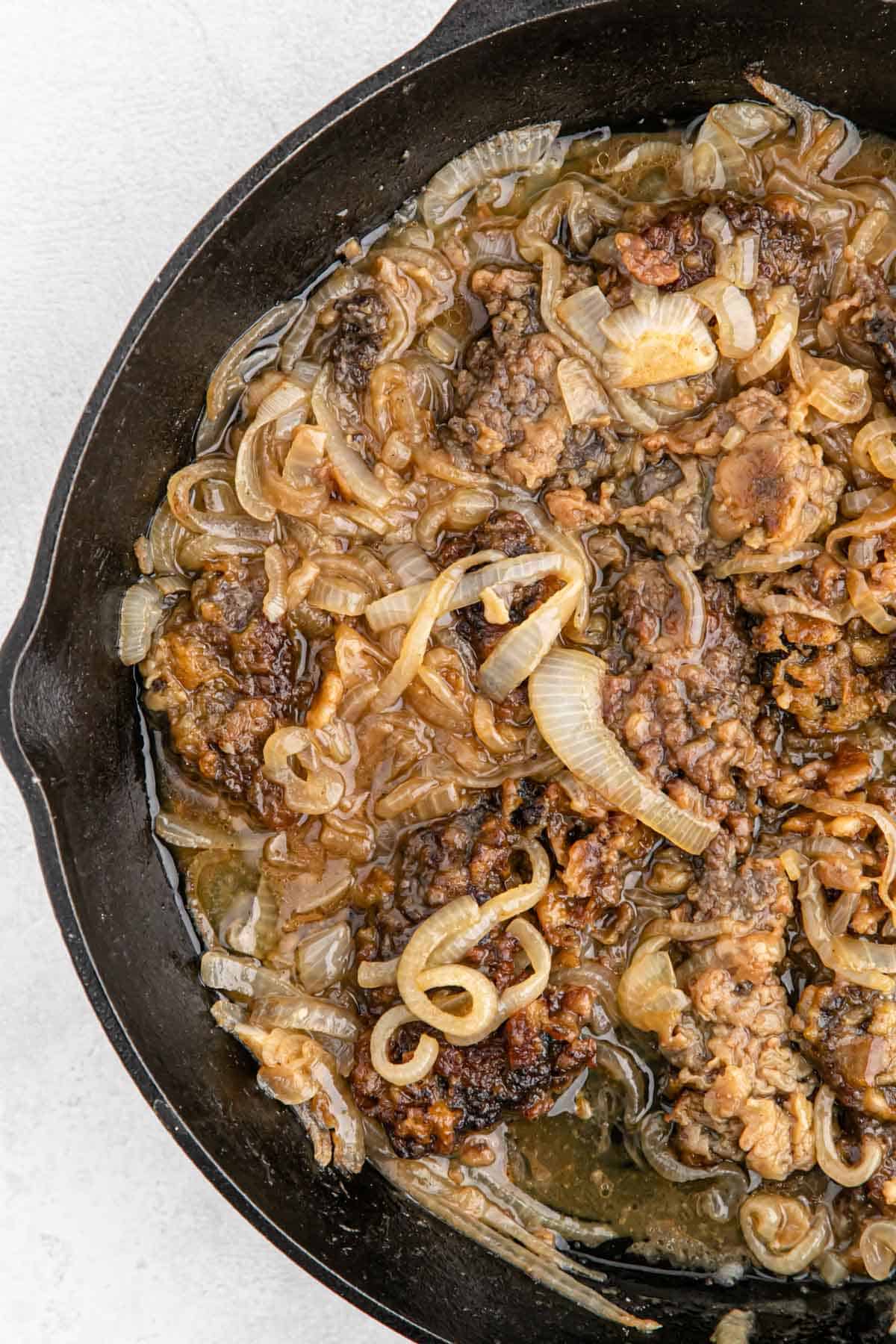 Juicy liver and onions recipe sitting on a pan