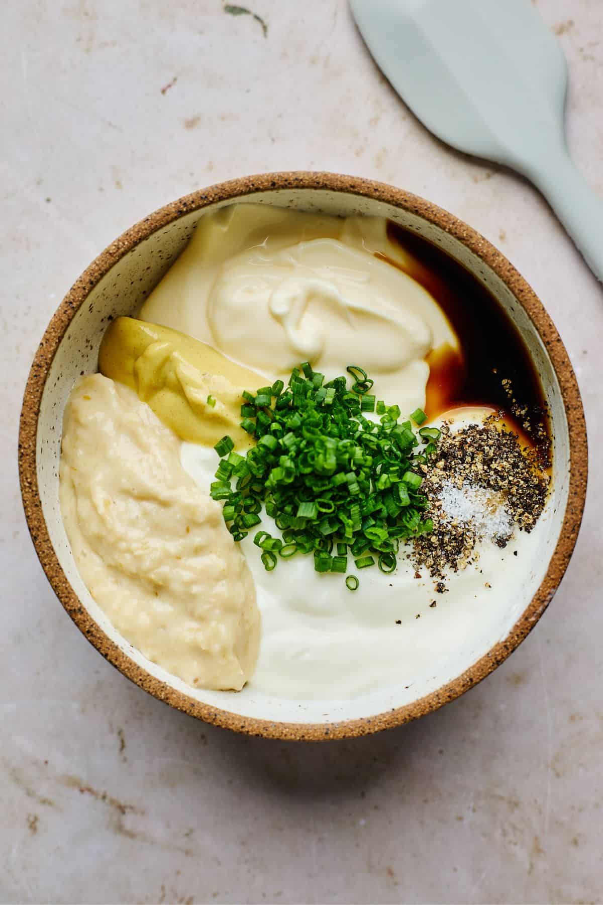 Overhead shot of ingredients for making horseradish sauce in a bowl before mixing