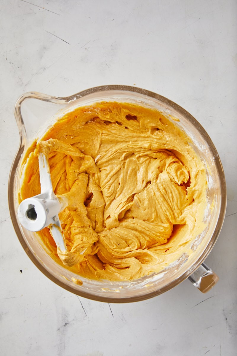 A pumpkin pound cake batter mixed together on a white countertop