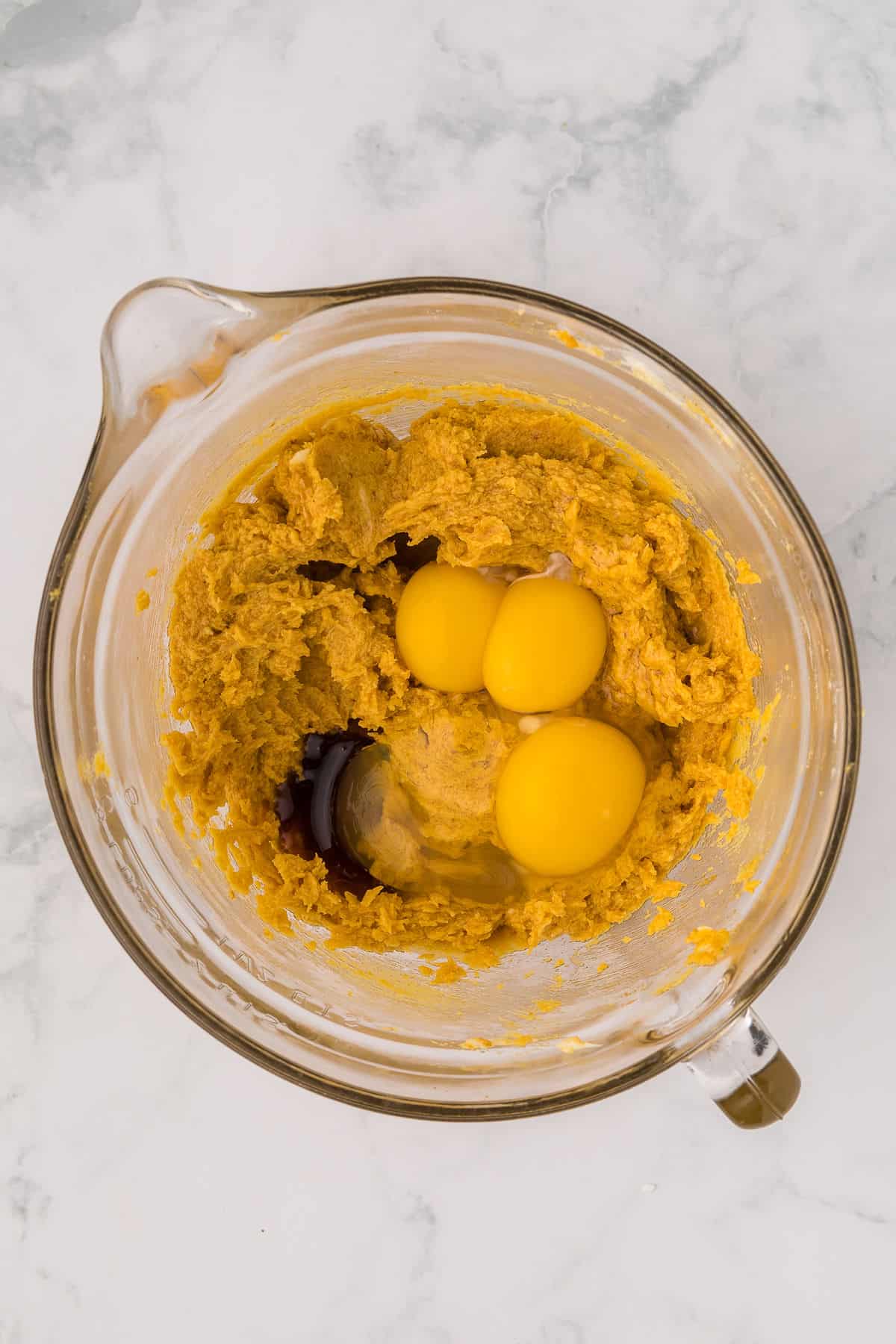 Eggs added to chocolate chip pumpkin cookie dough