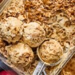 apple pie no churn ice cream in a dish with scopes taking out