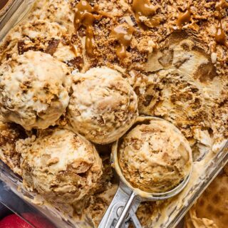 apple pie no churn ice cream in a dish with scopes taking out