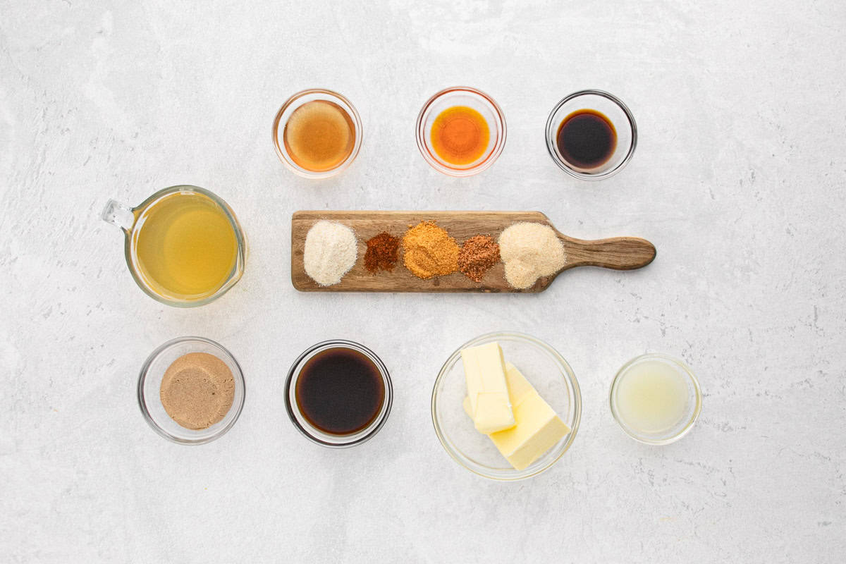 Overhead shot of ingredients for making the injection for fried turkey on a white surface before mixing