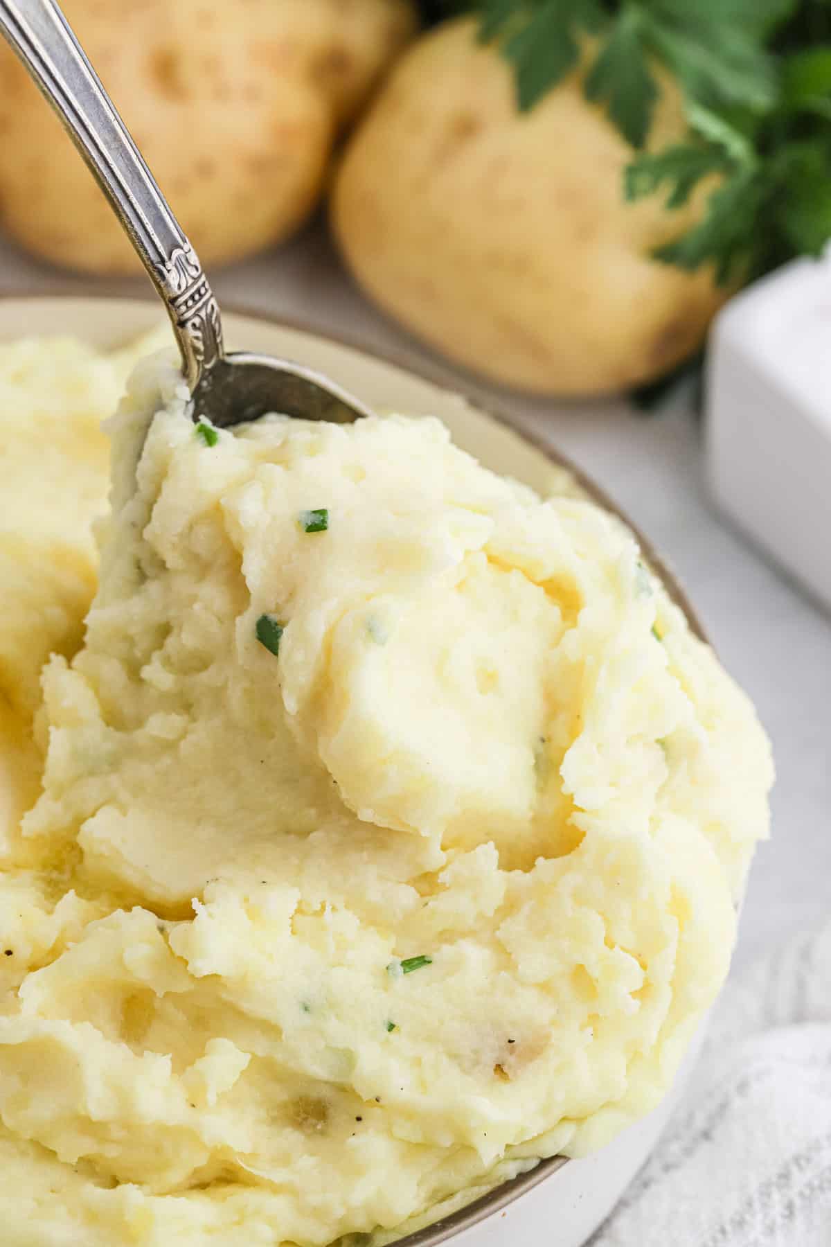 A spoon digging into creamy cream cheese mashed potatoes