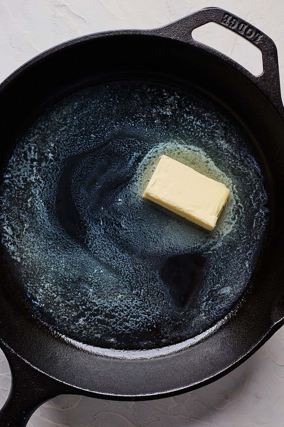 Butter melting in a cast iron skillet