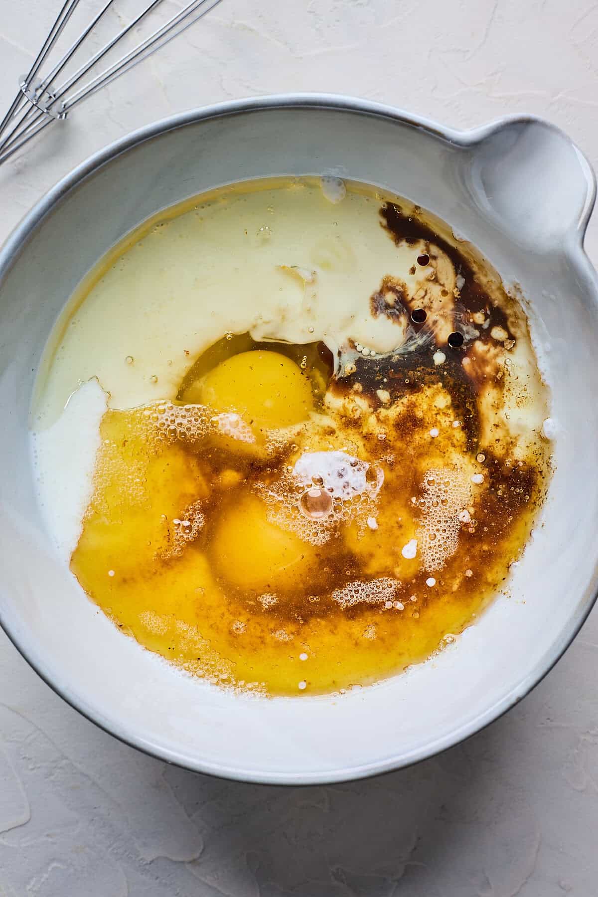 Buttermilk, eggs, butter and vanilla in a large mixing bowl before whisking