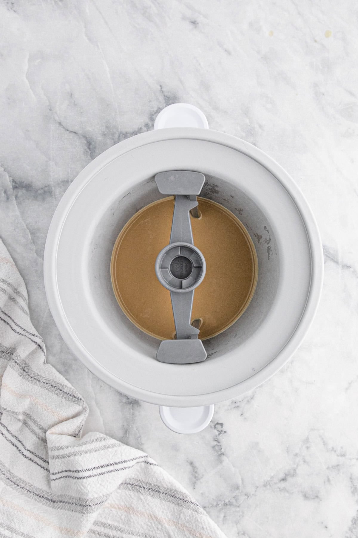 Cookie butter ice cream base chilling in an ice cream maker before churning