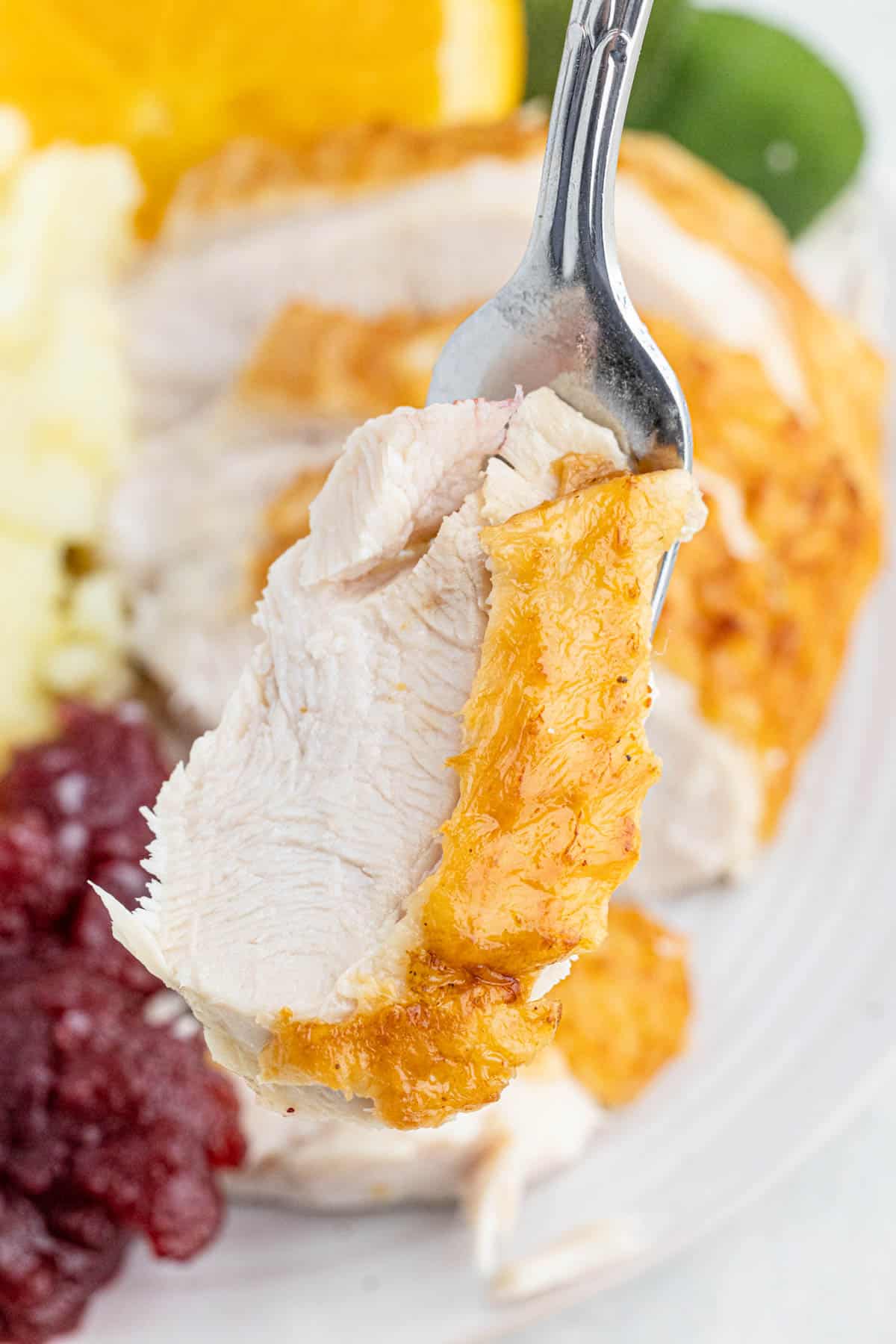 Fork picking up a slice of this juicy fried turkey recipe