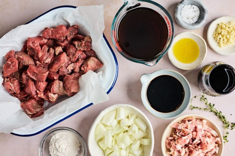 Beef pieces, stock, spices and ingredients to make easy beef tip recipe  on countertop