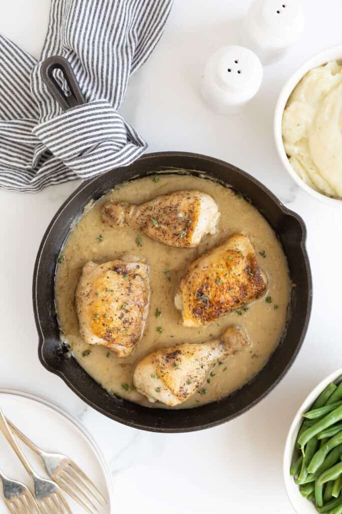 Finished chicken and gravy in a cast iron skillet ready to serve