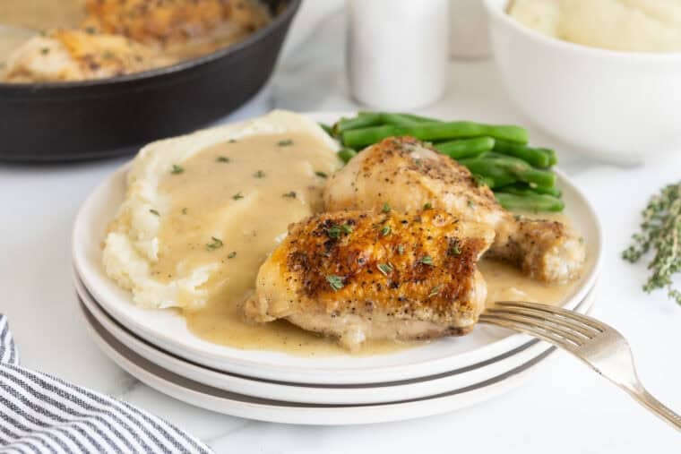 A plate with chicken and gravy ready to enjoy
