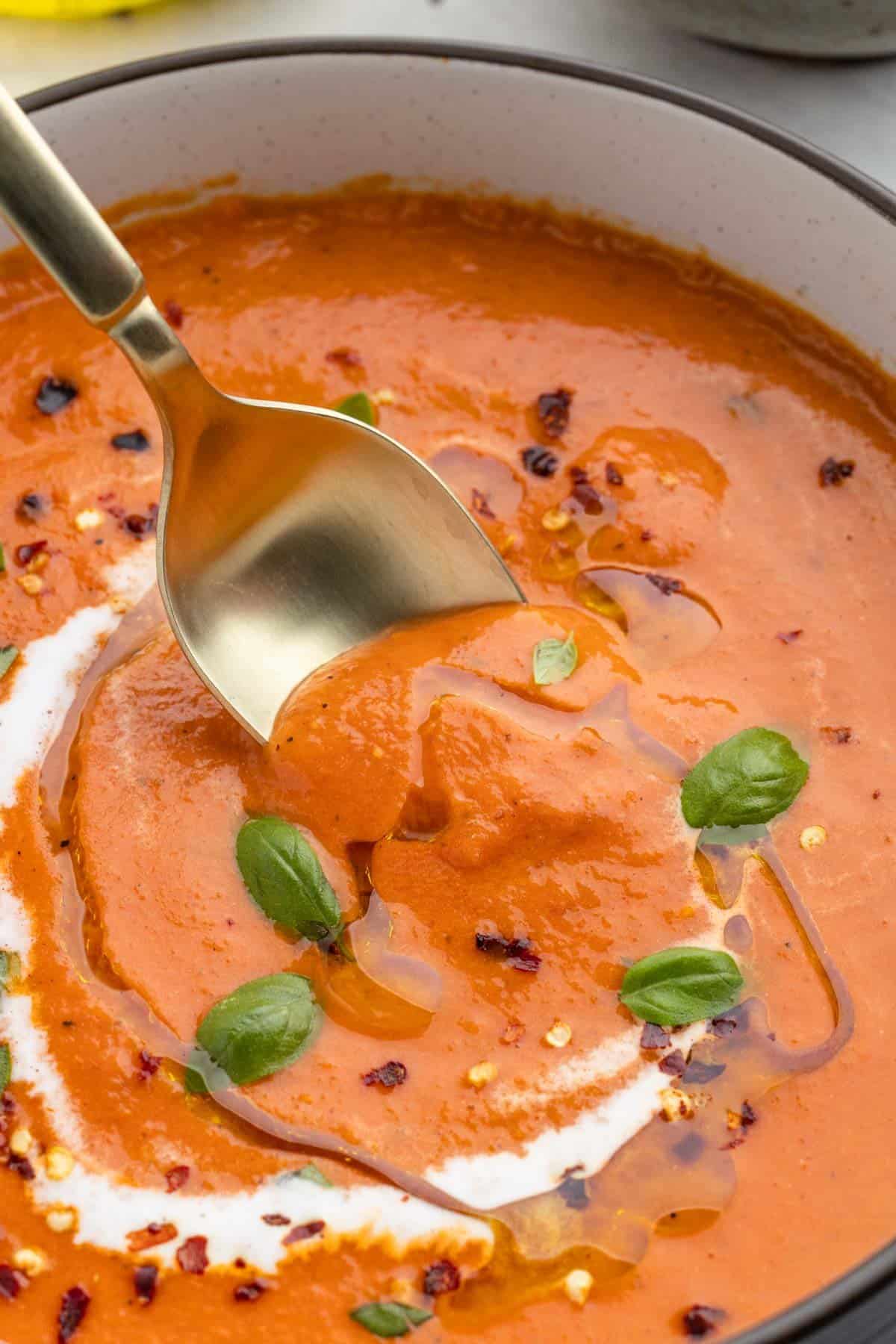 Closeup of this simple tomato soup with a spoon in it
