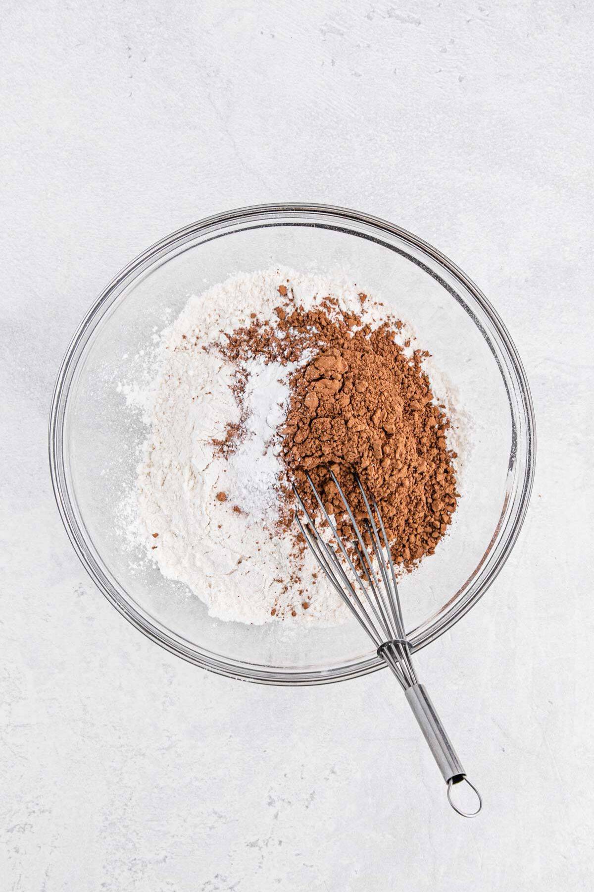 A bowl of dry ingredients being mixed with a whisk