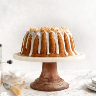 Coconut pound cake on a white cake stand