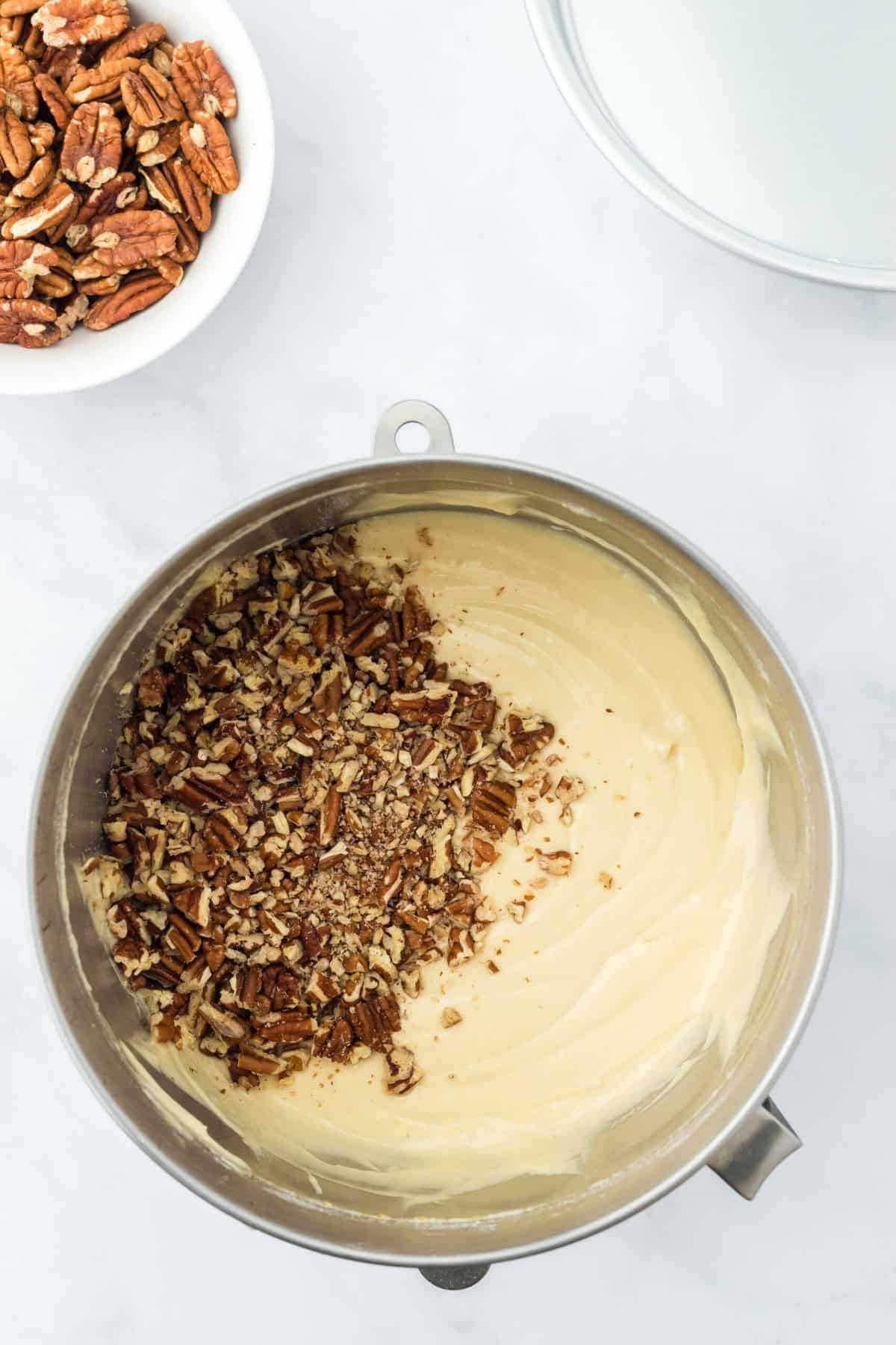 Pecans, being added to a cake batter