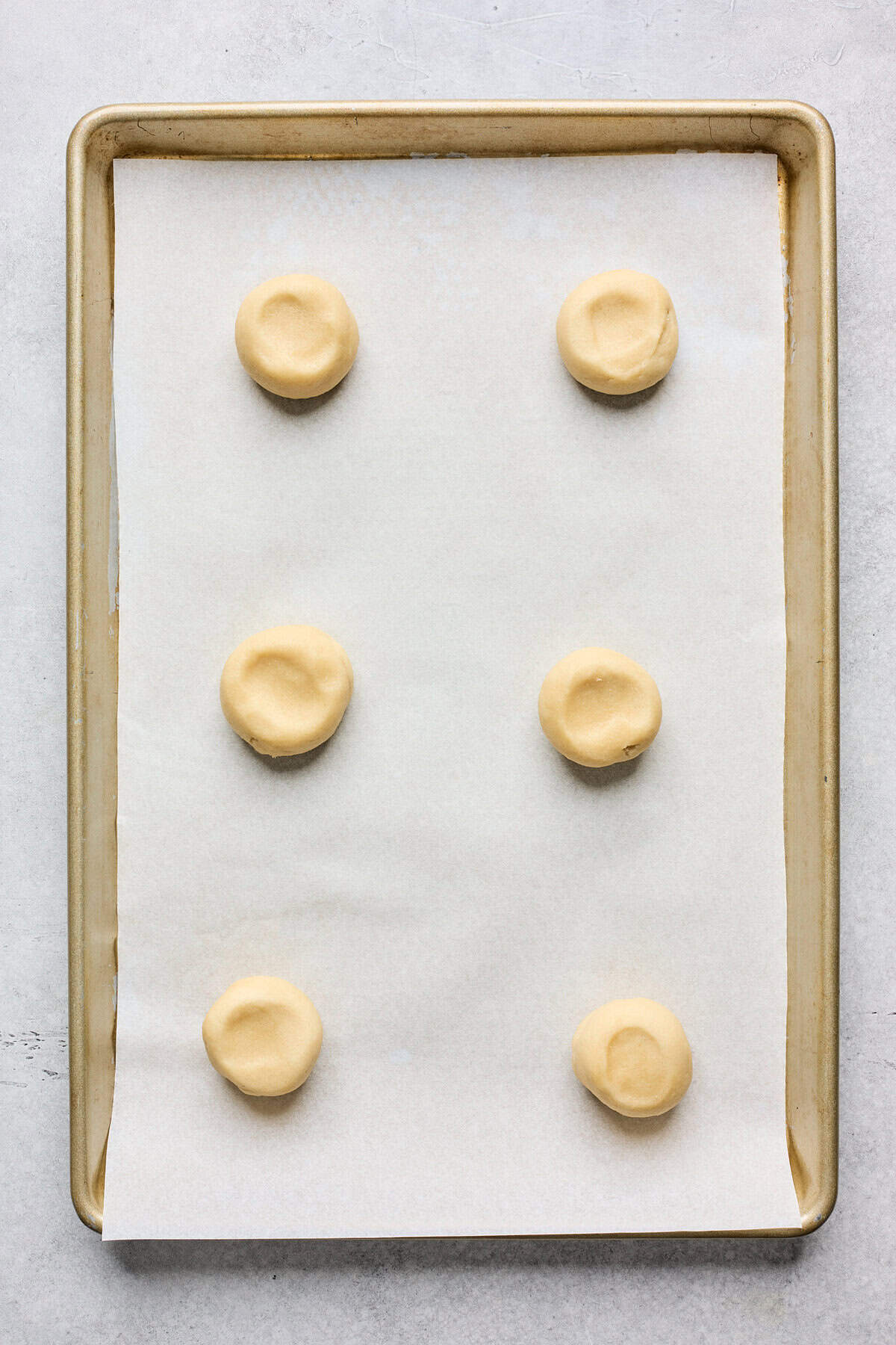 Tea cake dough on parchment sheet lined baking dish before baking