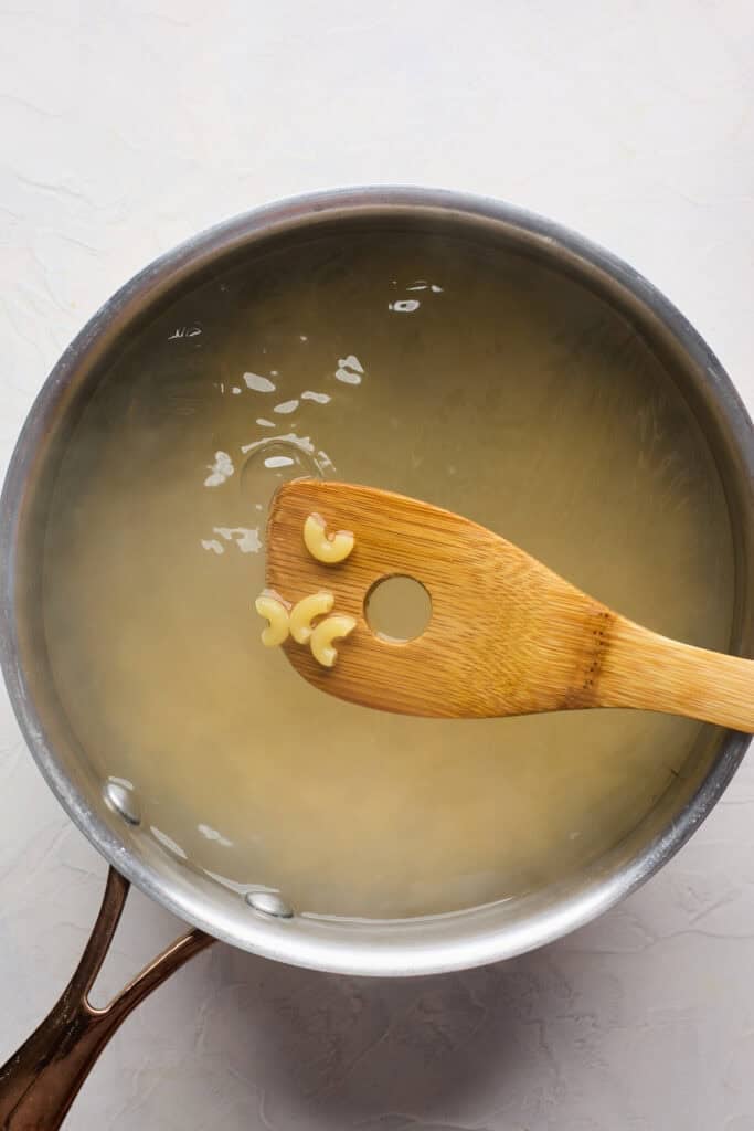 Macaroni noodles in water removed to show they. have boiled