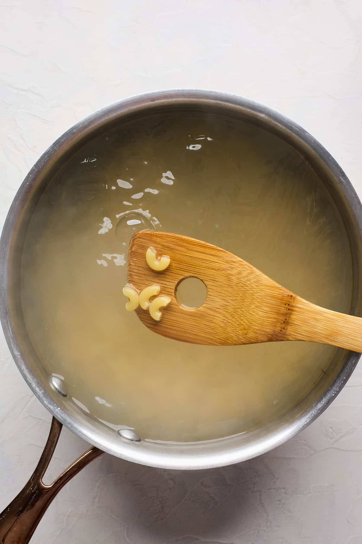 Macaroni noodles in water removed to show they. have boiled