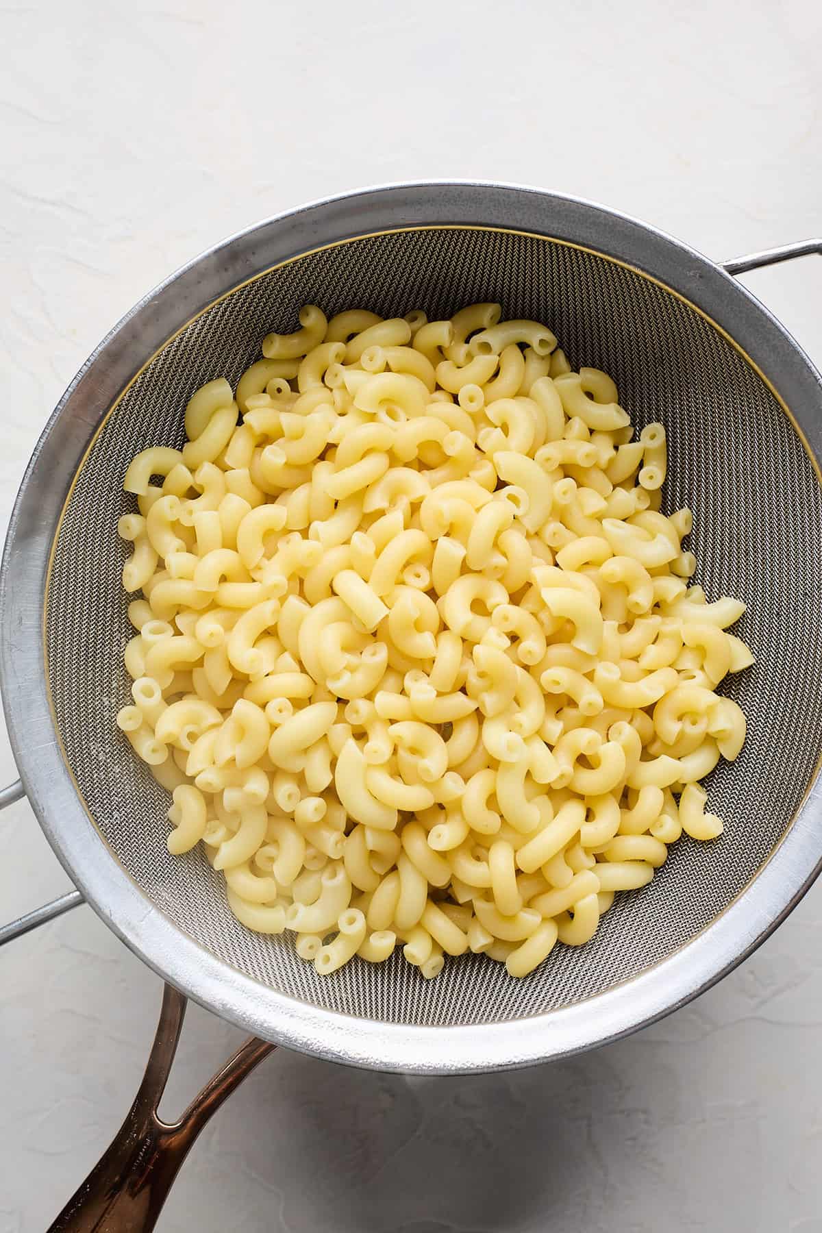 Drained elbow pasta in a bowl