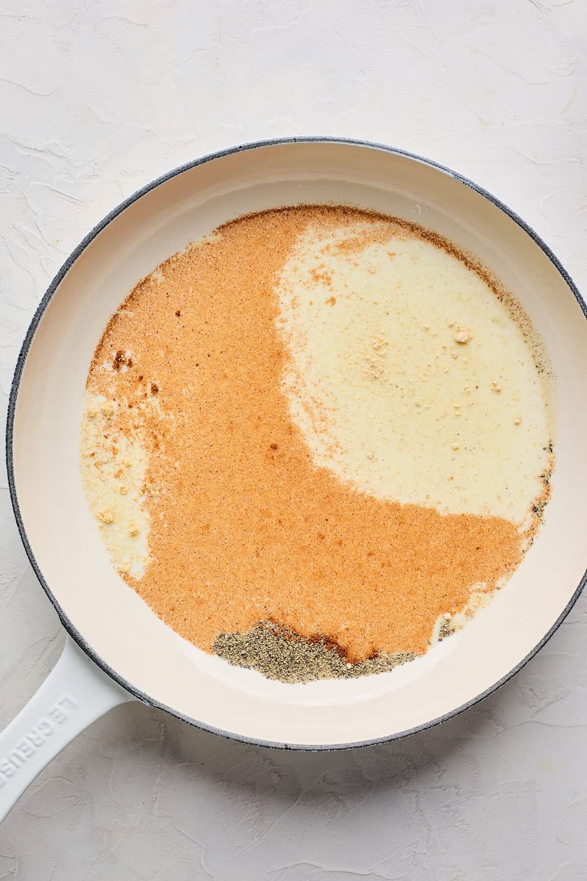 Spices in milk in skillet