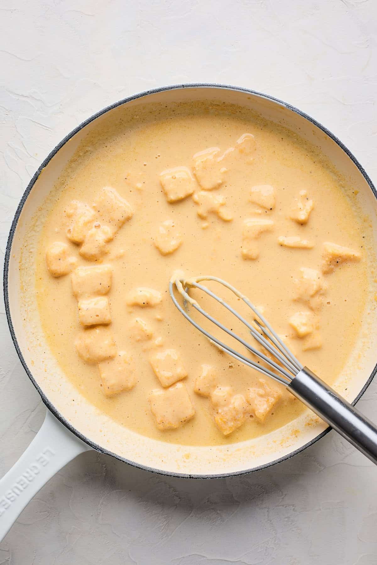 Velveeta cheeses melting in a large skillet