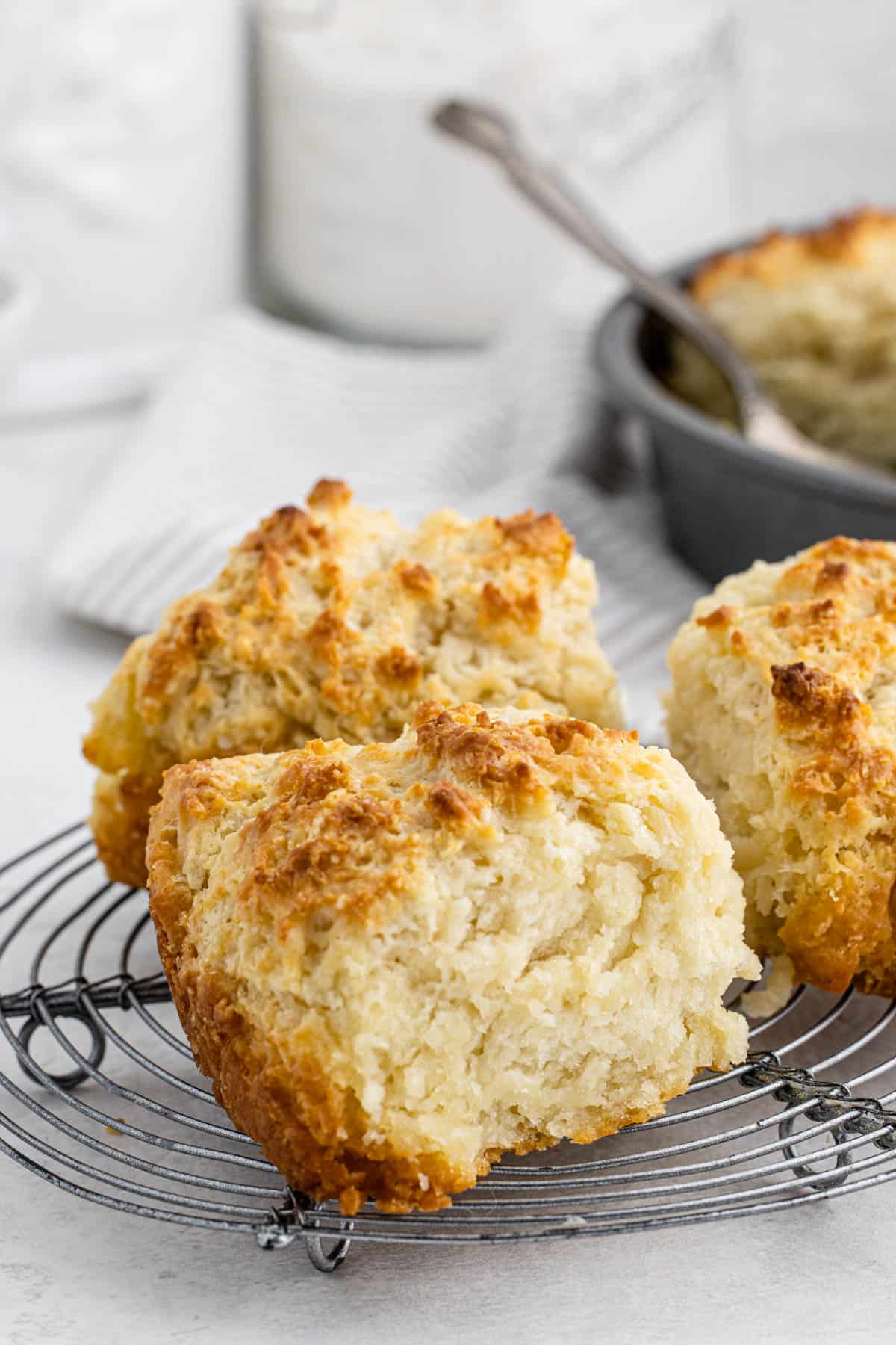 Three large cathead biscuits on a white background