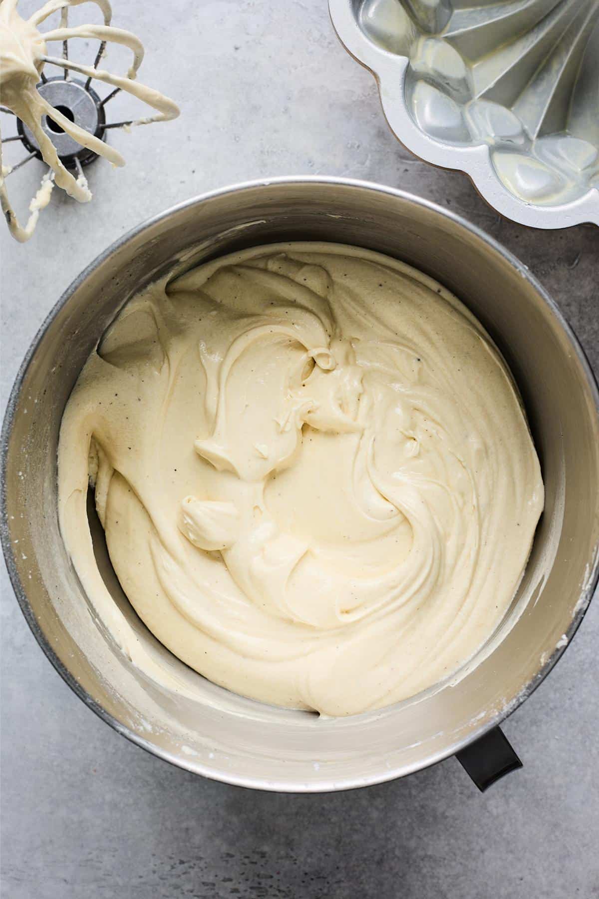 Fully mixed creamy batter, ready to be poured into a pan, sitting in the mixing bowl