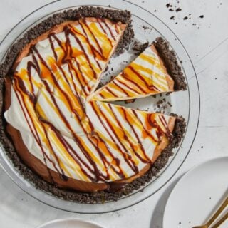 A cut up chocolate mousse pie on a gray background