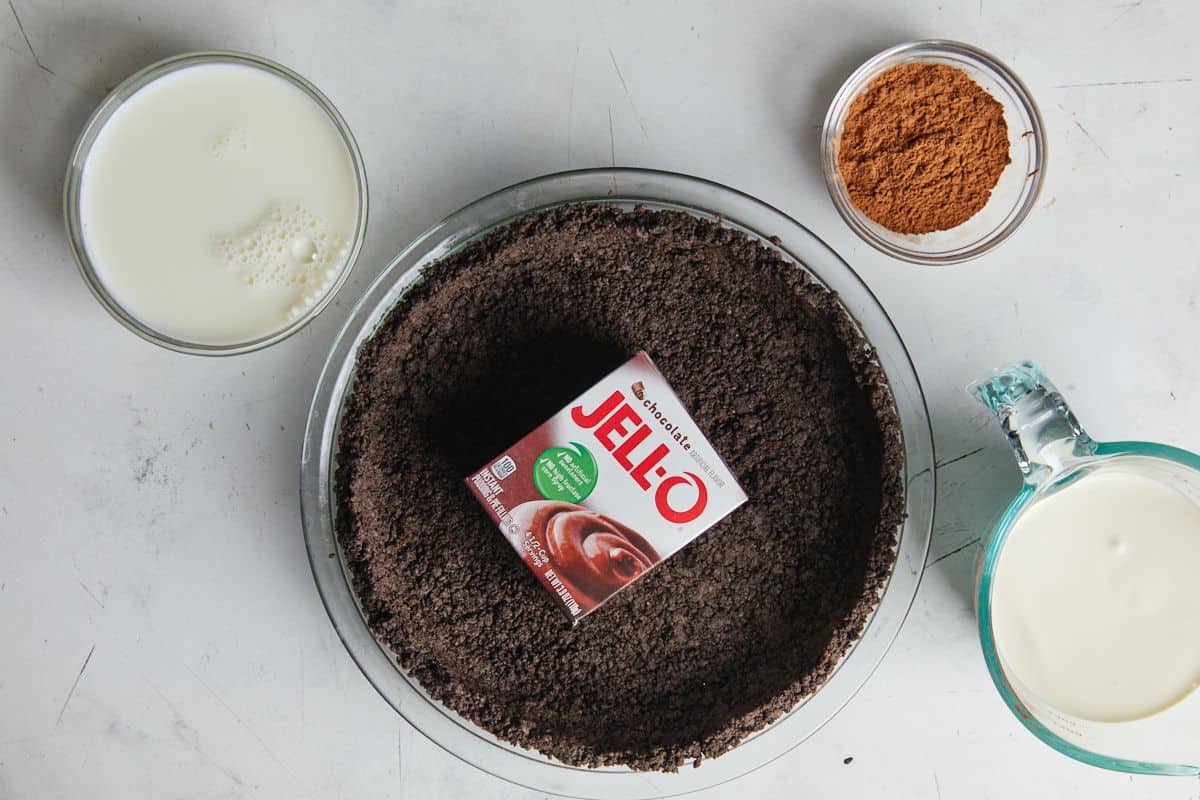 Ingredients to make chocolate mousse pie on a white surface before mixing