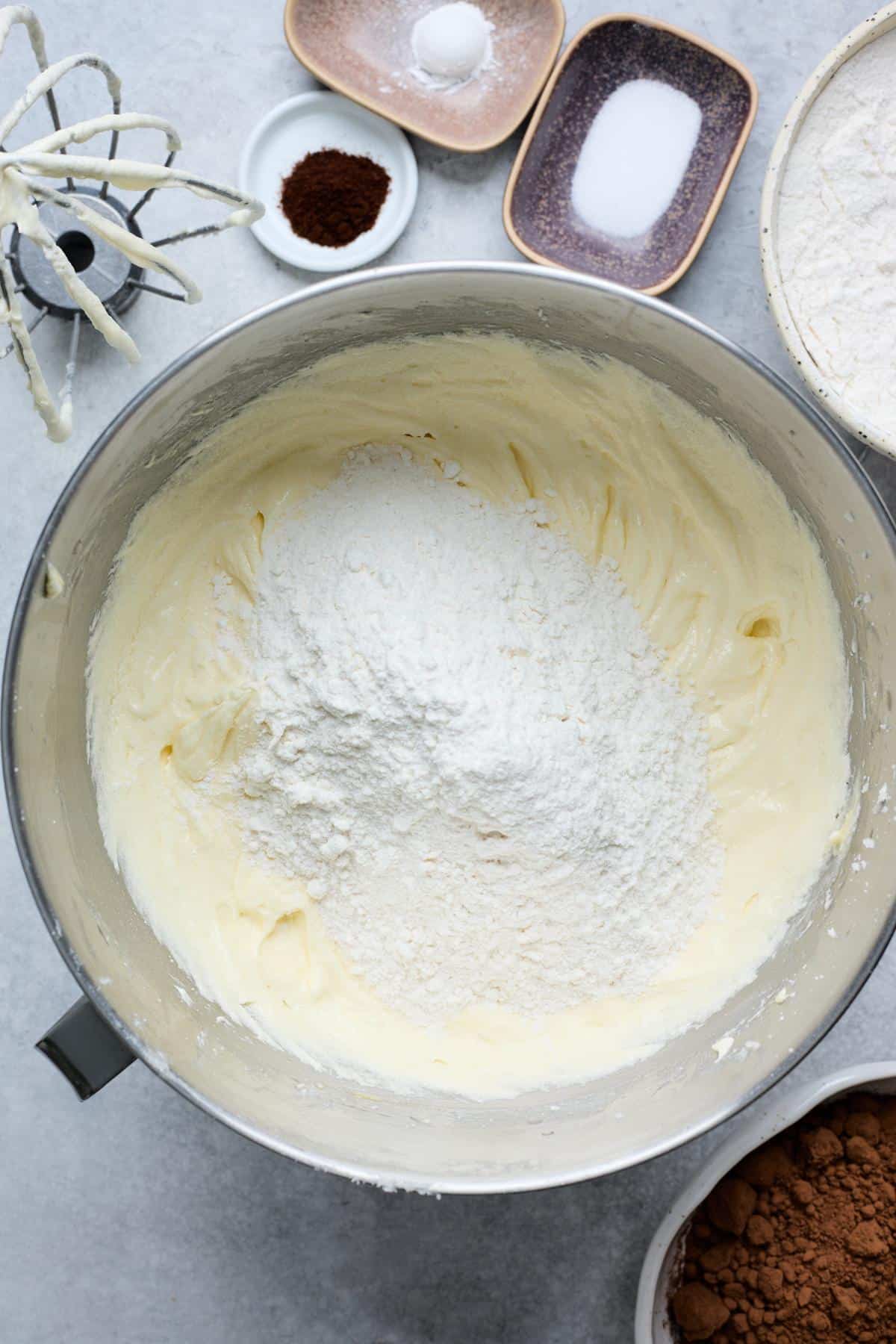 Dry ingredients, including flour, added to the creamed butter and sugar mixture