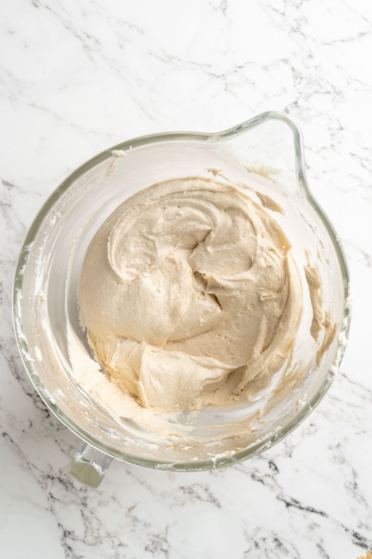 A finished bundt cake batter in a stand mixer before baking