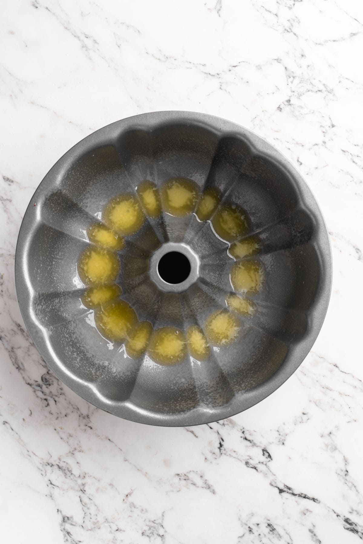 Melted butter in the bottom of a bundt pan