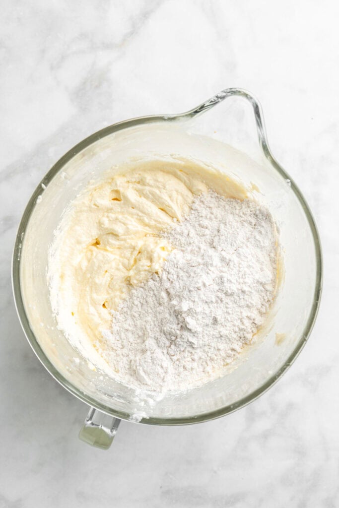 Flour added to cake batter in a mixing bowl