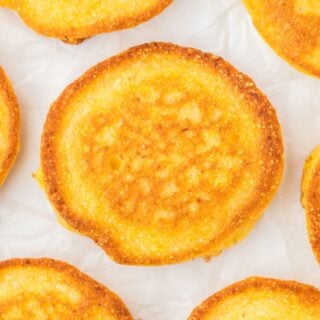 An overhead of fried cornbread on a white background