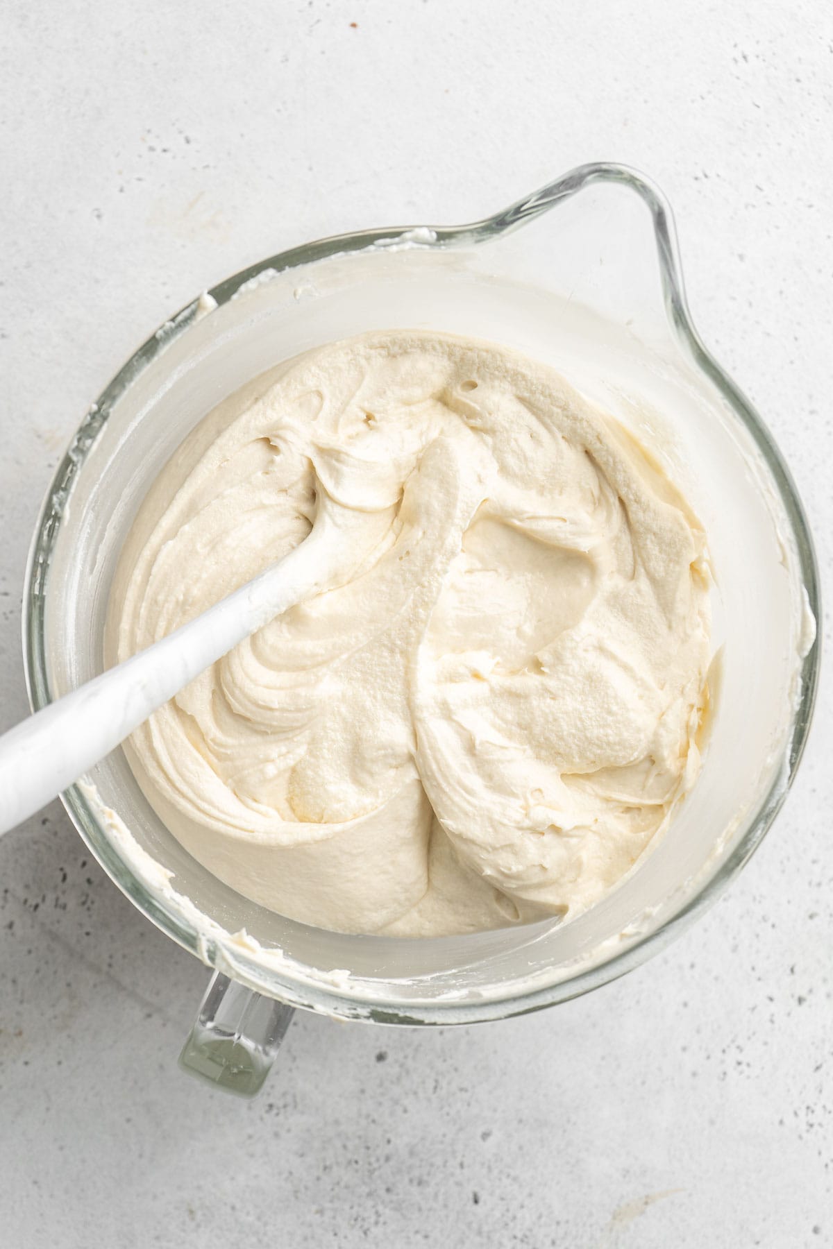 Cake batter mixed in stand mixer bowl ready to enjoy