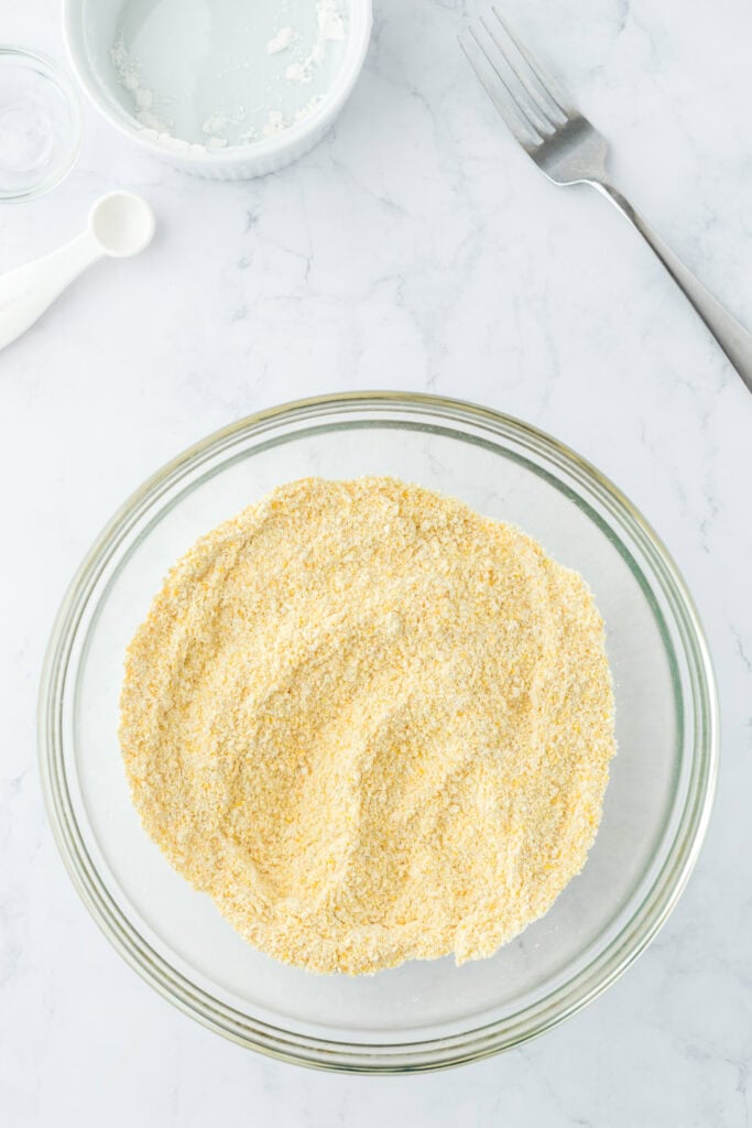 Cornbread dry ingredients in a glass bowl after being combined