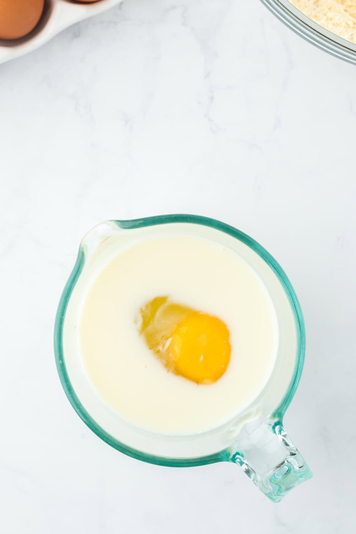 Buttermilk and egg in a glass measuring cup