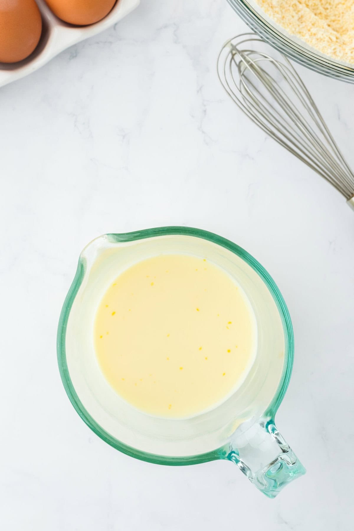 Liquid ingredients in a measuring cup whisked together